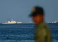 Филипински морски пехотинец наблюдава кораби на китайската брегова охрана край бреговете на остров Титу в контролираните от Манила спорни води в Южнокитайско море. 3 май 2026 г. Daniel Ceng / Anadolu / Getty